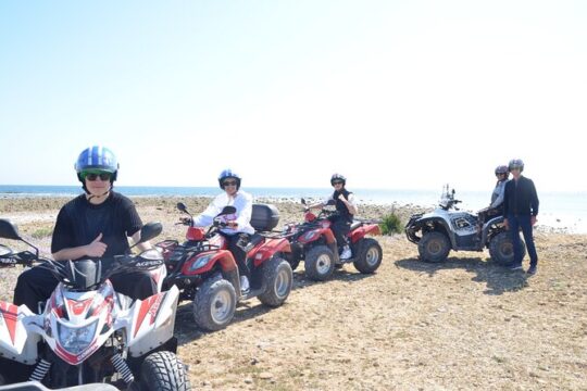 Quad tour between vineyards and the sea with a glass of wine.