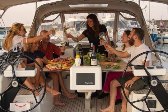 Wine tasting at sunset on a sailing boat in Riposto